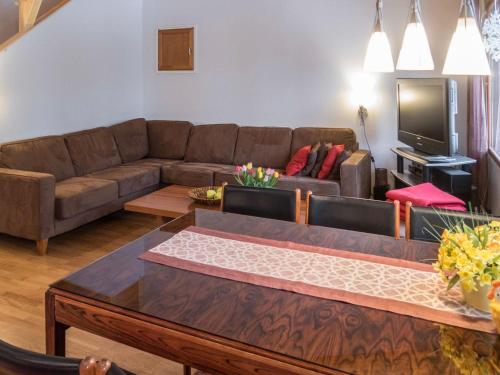 a living room with a couch and a tv at Holiday Home Karhunvartijan linna a7 by Interhome in Ruka
