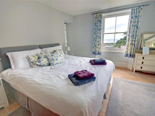 a bedroom with a bed with two towels on it at Holiday Home Ferndale House by Interhome in Lynmouth