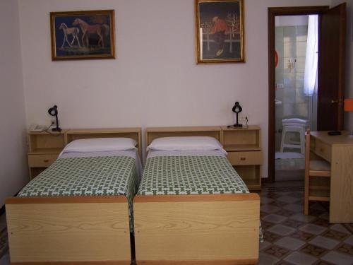 Postel nebo postele na pokoji v ubytování Albergo Corona