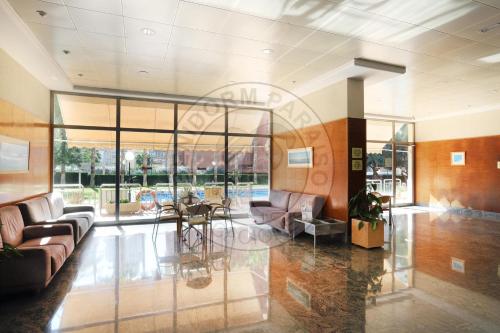 a lobby with couches and chairs and a table at Apartamentos Paraíso Centro - BenidormParaíso in Benidorm