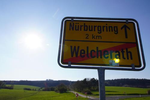 a yellow street sign on the side of a road at Nürburgring Aparts in Welcherath