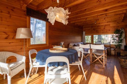 a dining room with a table and chairs in a cabin at Bungalow B2 - Nature, Beach & River in Ofir