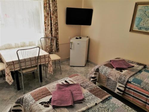 a room with two beds and a small refrigerator at Pokoje gościnne Zenon Nogal in Świnoujście