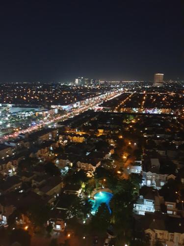 a view of a city at night with lights at M-Town Signature Gading Serpong by J`s Luxury Apartment in Pumpangsineng