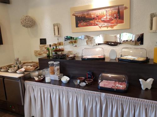 a counter top with a lot of items on it at Hotel Zur Brücke in Senheim