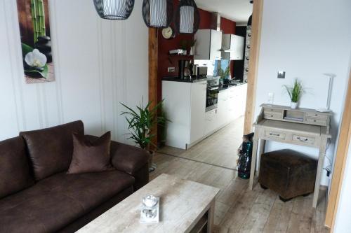 a living room with a couch and a table at Ferienwohnung-Thale-Ritter in Thale