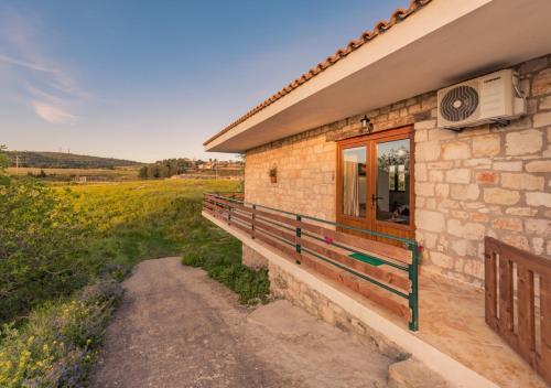 una casa de piedra con una ventana y un camino de tierra en Villa windmill Near Shipwreck Beach by "elite", en Volímai