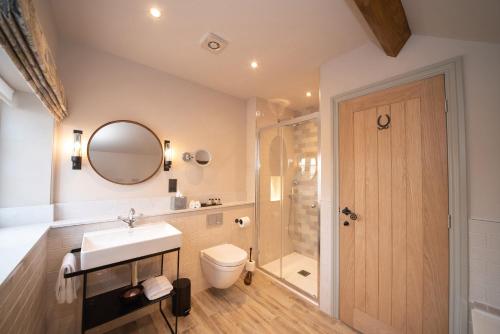 a bathroom with a sink and a shower and a toilet at The Farrier in Scarborough