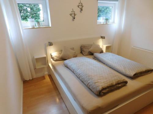 a bed in a room with two pillows on it at Ferienwohnung Elsbeere in Blankenheim