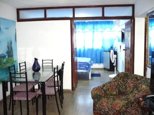 a living room with a table and a couch at Apartamento UltraMar in Matanzas