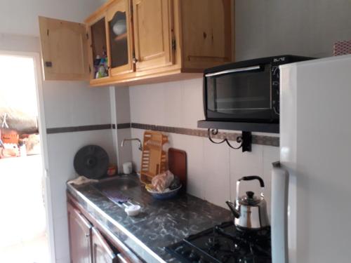 een kleine keuken met een fornuis en een magnetron bij Relaxation apartment in Marrakesh