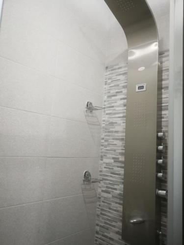 a bathroom with a shower with a glass door at The White House in Palamartsa in Palamarca