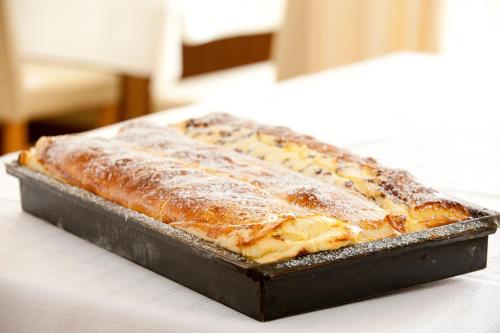 two slices of pizza in a pan on a table at Hotel-Restaurant Gollner in Lebring