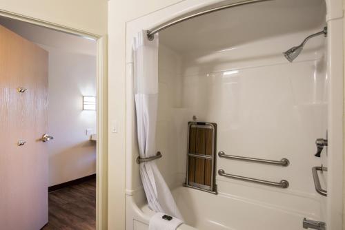 a bathroom with a shower and a toilet at Red Lion Inn & Suites Butte in Butte