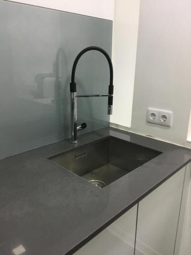 a kitchen sink with a faucet on a counter at ALTAMIRA HOUSE in Viana do Castelo