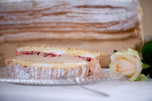 a piece of cake on a glass plate with a cake at Hotel-Restaurant Gollner in Lebring