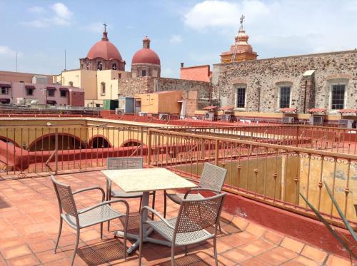 a table and chairs on the roof of a building at Hotel Quinta Santiago in Querétaro