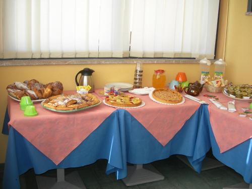 a table with a blue table cloth with food on it at Caffè Nuovo 2 Holiday Rooms in Trappitello