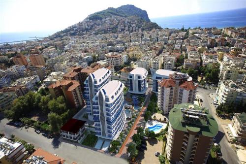 een luchtzicht op een stad met gebouwen en de oceaan bij Elite Marine Residence - Cleopatra, center in Alanya