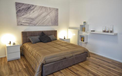 a bedroom with a large bed with two night stands at Maison Sama ' in Andria