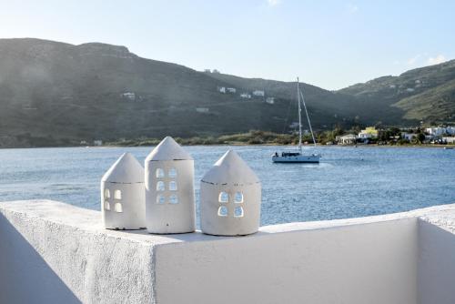 two sand castles sitting on a wall next to the water at The Veranda of Gavrion-Exclusive, Centrally located with Seaview in Gavrion