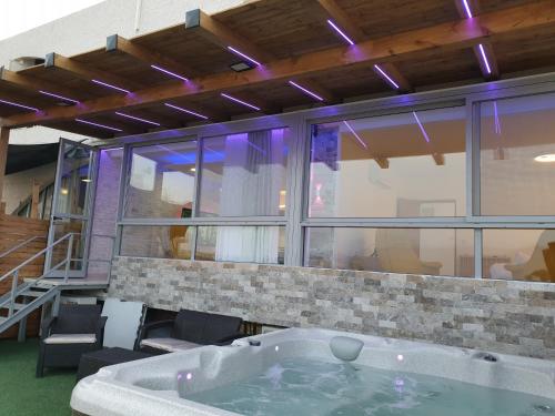 a large bath tub in a room with windows at Avshalom Holiday Apartments in Eilat