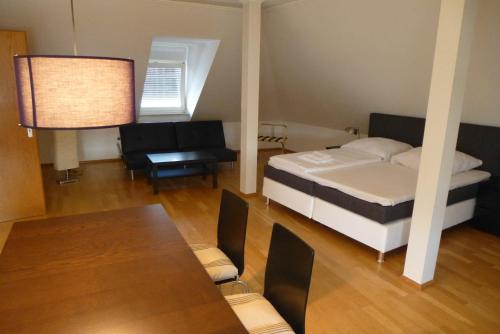 a small room with a bed and a table at Zum Löwen in Bad Homburg vor der Höhe