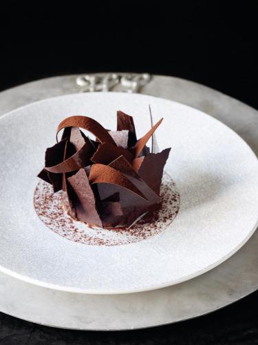 a chocolate dessert on a white plate on a table at Huka Lodge in Taupo