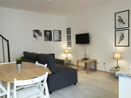 a living room with a couch and a table at BmyT - The Villa in Lisbon