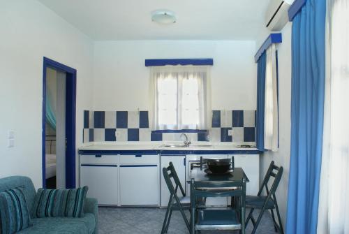 a kitchen with a table and chairs and a sink at Villa Antoniadis in Platis Yialos Sifnos