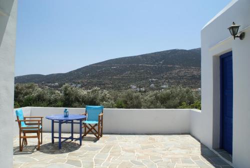 a table and chairs on a patio with a view at Villa Antoniadis in Platis Yialos Sifnos