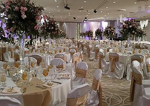 a large banquet hall with white tables and chairs at Bally's Lake Tahoe Casino Resort in Stateline