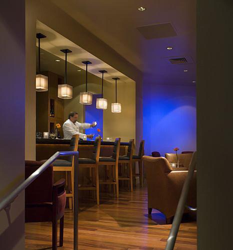 a man standing at a bar in a restaurant at Bally's Lake Tahoe Casino Resort in Stateline