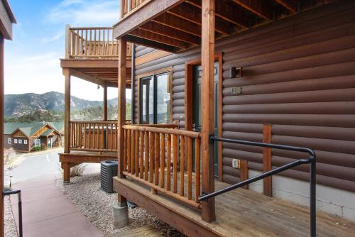 a wooden house with a deck and a balcony at Chiefs Head Peak 21B Condo in Estes Park