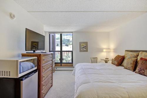 a bedroom with a large bed and a tv at MP518 Mountain Plaza Hotel Room in Copper Mountain