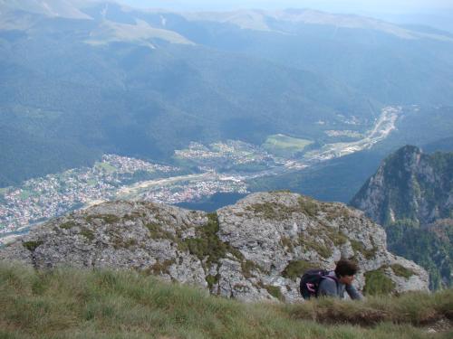 a man sitting on top of a mountain at Complex Mona Caraiman in Buşteni