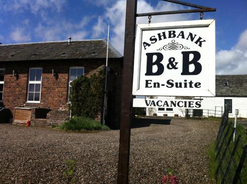 a sign in front of a brick building with a sign for a beb end at Ashbank Bed & Breakfast in Drymen