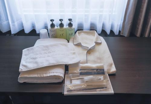 a table with towels and cleaning products on it at KKR Hotel Osaka in Osaka