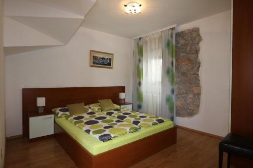 a bedroom with a large bed in a room at Apartments Ervin in Šilo