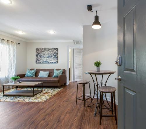a living room with a couch and a table at Amazing Midtown Atlanta Location by Piedmont Park Beltline Ponce City Market in Atlanta