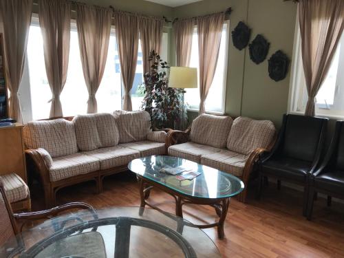 a living room with couches and a coffee table at Cardinal Court Motel in Saint Thomas