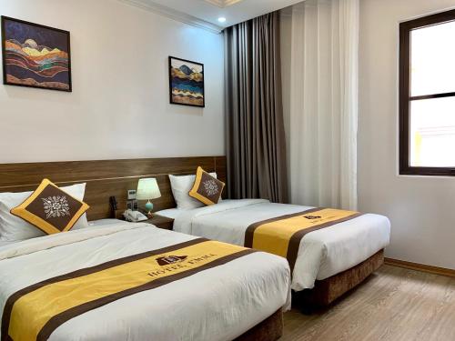 Ένα ή περισσότερα κρεβάτια σε δωμάτιο στο Emma Hotel