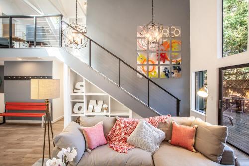 a living room with a couch and a staircase at 758 Broadway House in Sonoma