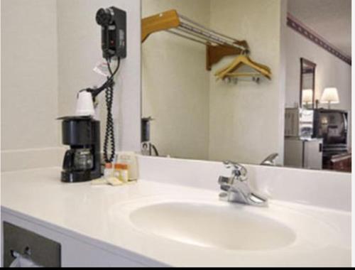 a bathroom counter with a sink and a mirror at Days Inn by Wyndham Eufaula AL in Eufaula