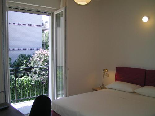 a bedroom with a bed and a large window at Anania in Cagliari