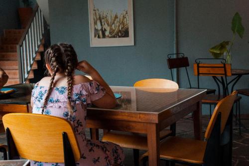 a woman sitting at a table in a room at Motel Nomad in Cairns