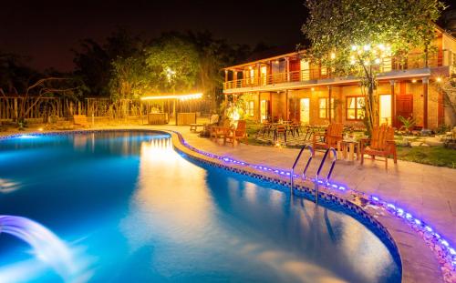 a swimming pool in front of a house at night at Tam Coc Lavender Homestay -Authentic Ninh Binh Experiences in Ninh Binh