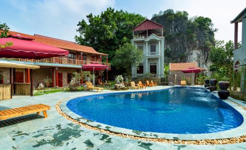 a swimming pool in front of a house at Tam Coc Lavender Homestay -Authentic Ninh Binh Experiences in Ninh Binh