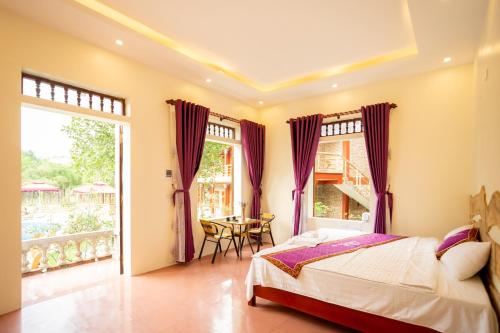 a bedroom with a bed and a table at Tam Coc Lavender Homestay -Authentic Ninh Binh Experiences in Ninh Binh