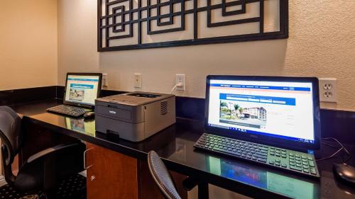 a desk with a laptop computer and a printer at Lompoc Valley Inn and Suites in Lompoc